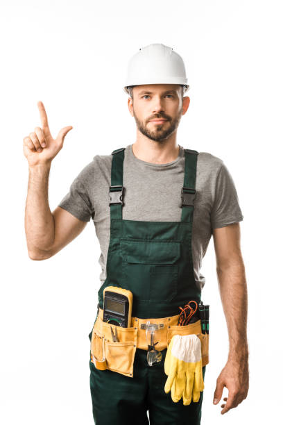 istock handsome electrician with tool belt pointing up isolated on white 1049771448
