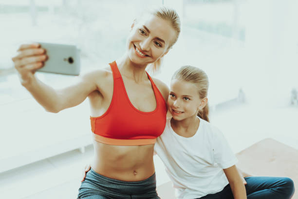 istock Mum And Daughter Are Doing Selfie On Gym Carpet. 1049774822
