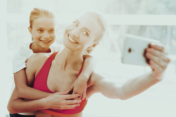 istock Mum And Daughter Are Doing Selfie On Gym Carpet. 1049774840
