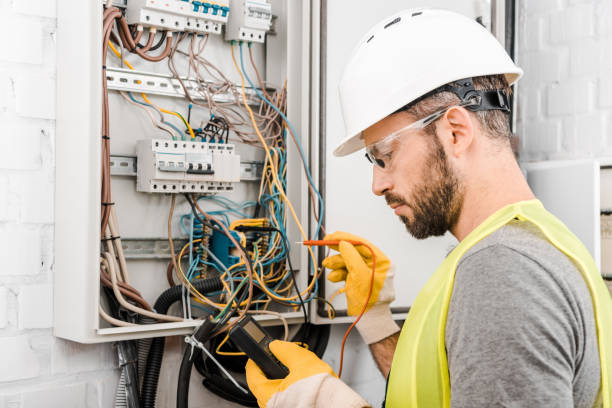 istock handsome electrician checking electrical box with multimetr in corridor 1049775262