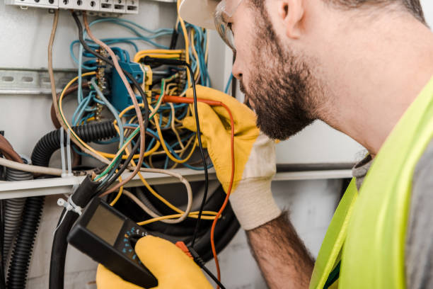 istock side view of electrician checking electrical box with multimetr in corridor 1049775274