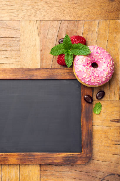 Black chalkboard with pink glazed donut