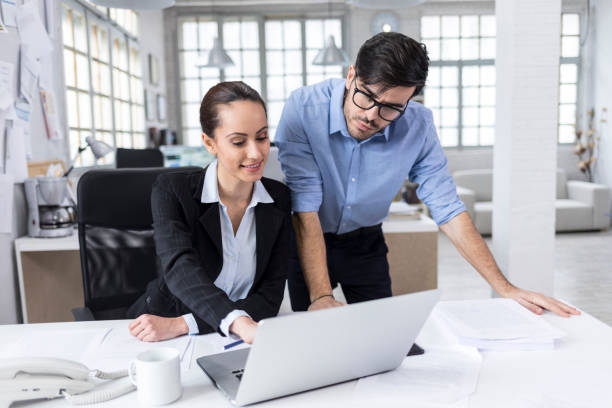 istock Businessman and female assistant in modern office 1049784810