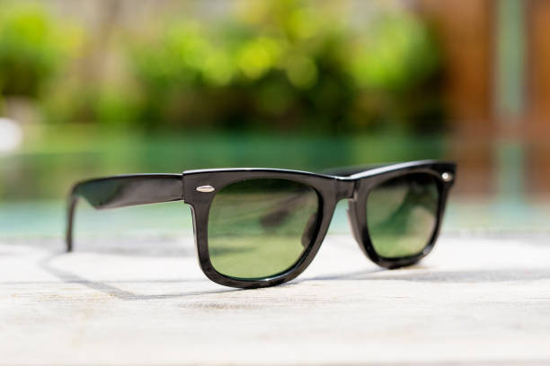 istock Black sunglasses next to swimming pool 1049785188