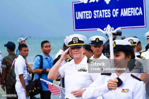 Greeting Us Navy Officer With Small Us Flag Stock Photo - Download Image Now - Asia, US Navy, Adult