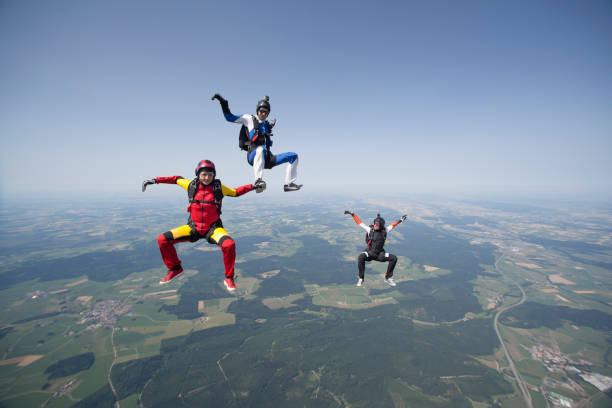 istock Skydivers plunge through lofty skies above rural area 1049791508