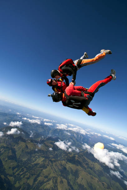 istock Skydivers plunge through lofty skies above mountains 1049791538