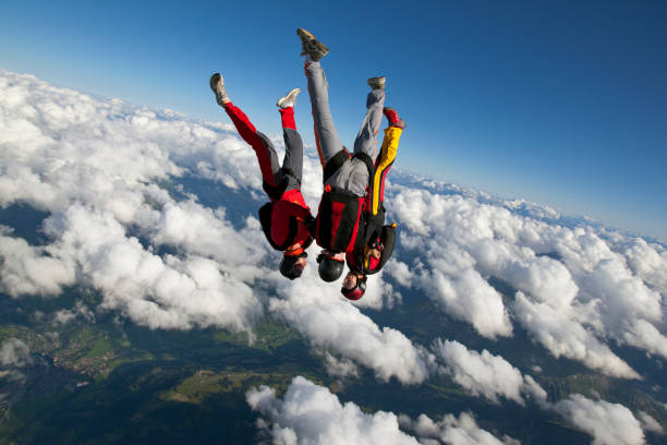 istock Skydivers plunge through lofty skies above mountains 1049791600