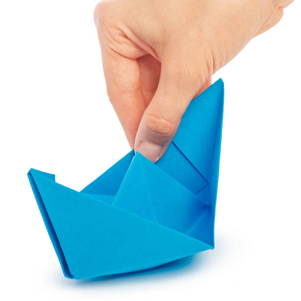 istock Paper ship in a female hand 1049797946