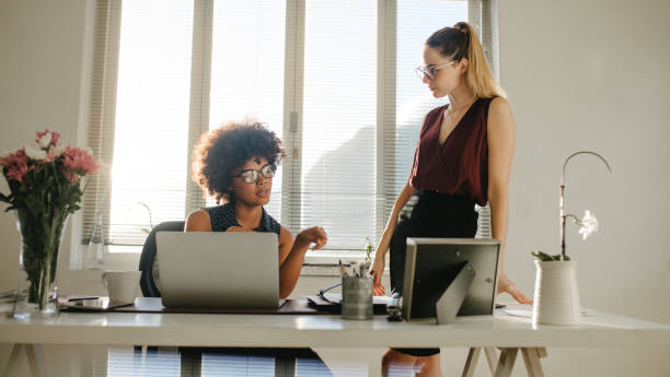 istock Two businesswoman discussing work in office 1049802296