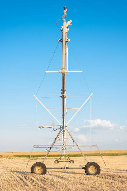 istock industrial irrigation sprinklers in the foreground under blue sky 1049807462