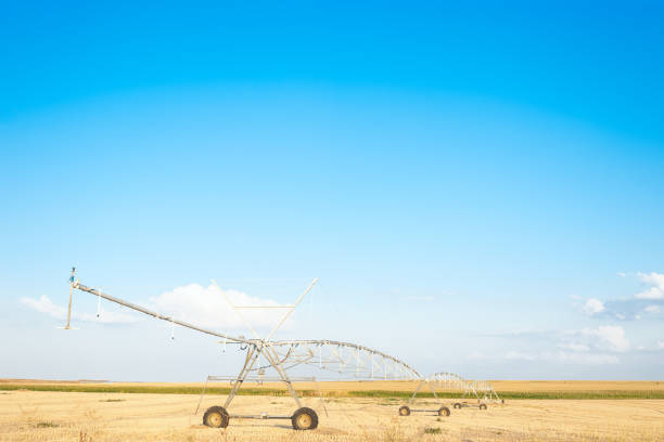 istock industrial irrigation sprinklers in the foreground under blue sky 1049807862