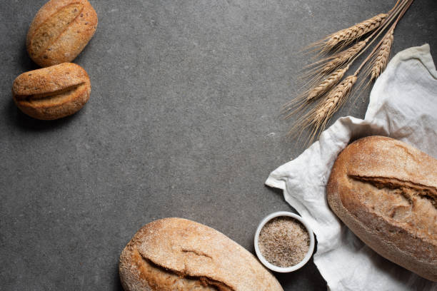istock flat lay with arranged bread loafs and wheat on grey tabletop 1049808216