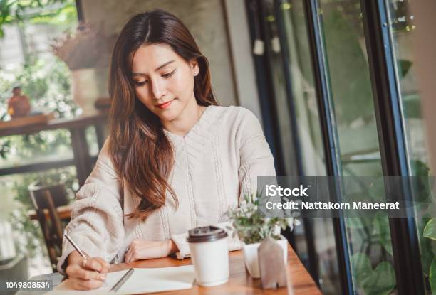 Close Up Asian Woman Hand Writing On Notebook Stock Photo - Download Image Now - Handwriting, Writing - Activity, Letter - Document
