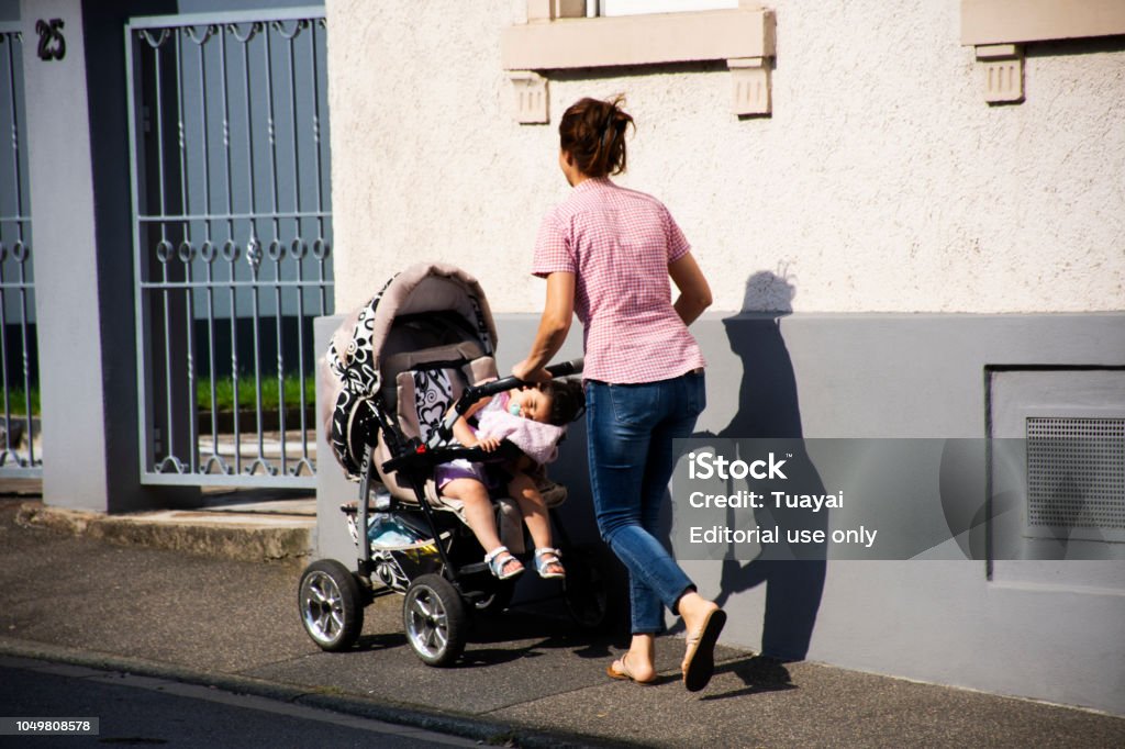 praktiserende læge handicap At Mother German People Push Stroller Carriage With Baby On Footpath At Beside  Road In Sandhausen Stock Photo - Download Image Now - iStock