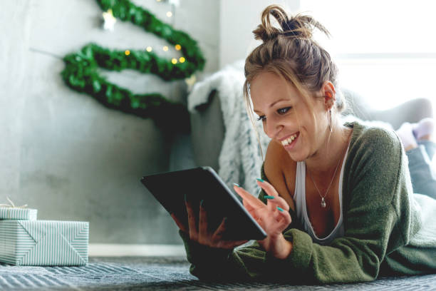 istock Smiling woman looking at digital tablet 1049812696