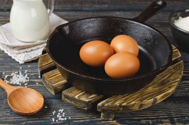 istock Whole raw eggs in a pan on a wooden table 1049813084