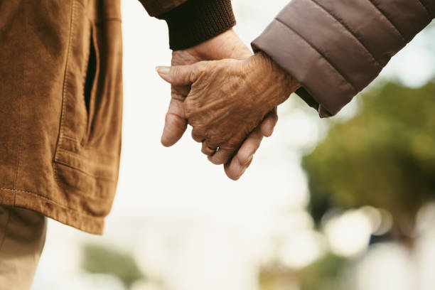 istock Together forever - Old couple walking hand in hand 1049815332