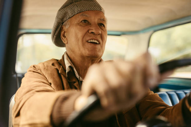 istock Senior man enjoying driving his car 1049815538
