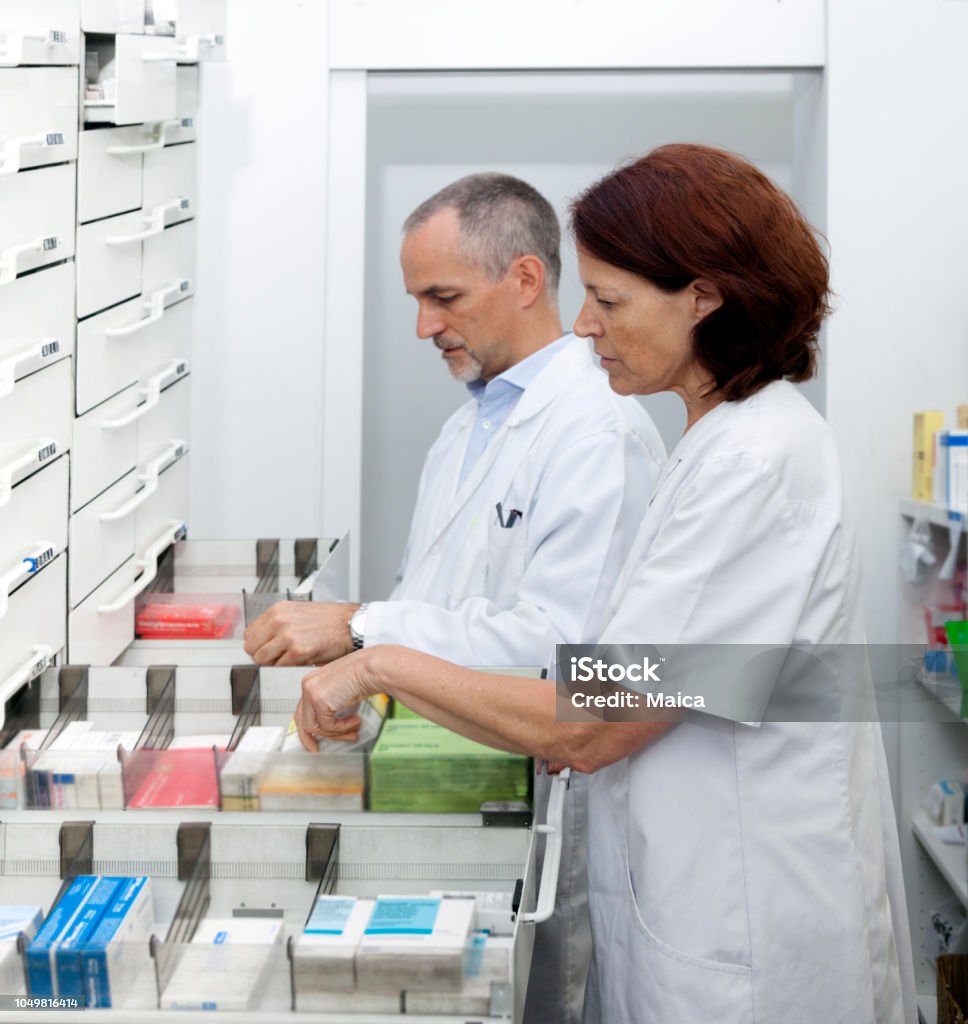 Pharmacists organizing medicines Pharmacy Stock Photo