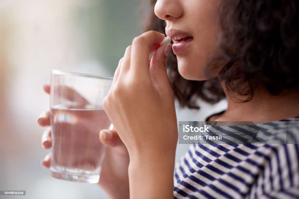 This will make me feel better Cropped shot of an unrecognizable teenage girl drinking medication Medicine Stock Photo