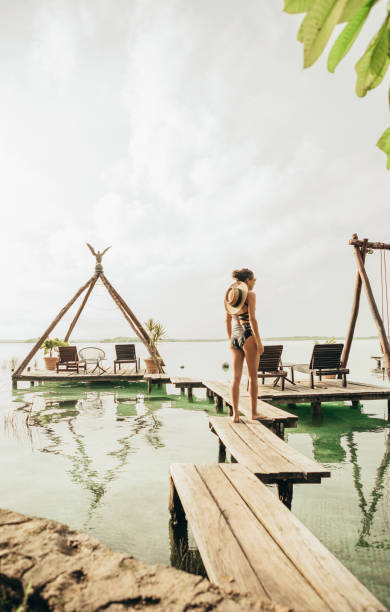 istock Woman walking on a pier at a lagoon 1049820116