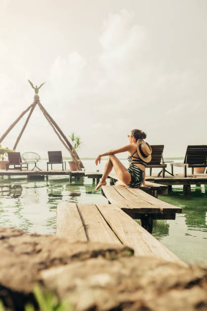 istock Woman walking on a pier at a lagoon 1049820180