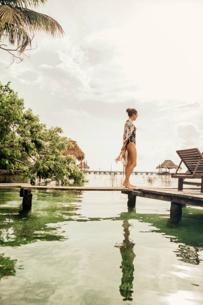 istock Woman walking on a pier at a lagoon 1049820284