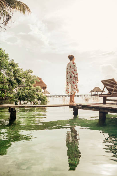 istock Woman walking on a pier at a lagoon 1049820286