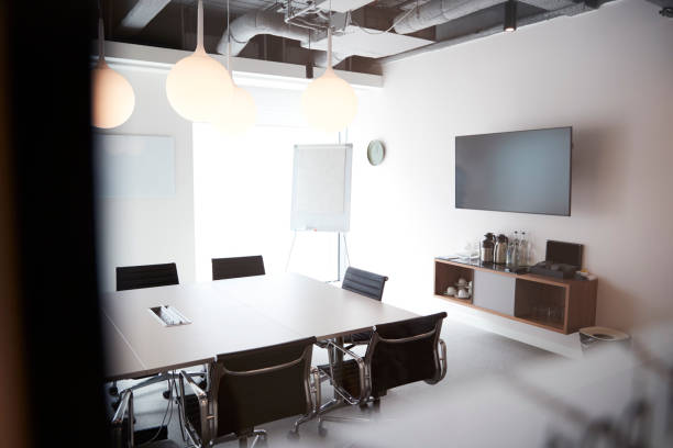 istock Chairs Around Boardroom Table In Empty Modern Meeting Room 1049825946