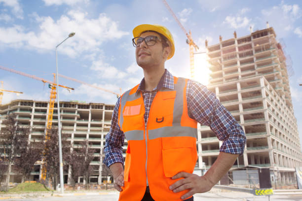 istock Young Engineer portrait with construction site and crane background. 1049831584