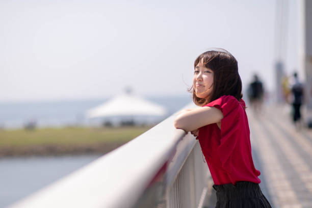 istock Young woman resting on bridge 1049832748