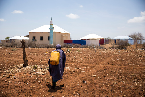 Baidoa / Somalia - March 2017 -Somalian girl carries water to her house during deadly drought.