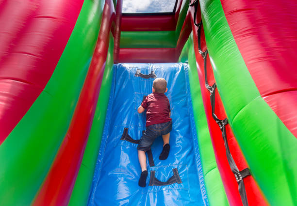 istock High Angle View Of Boy Playing On Colorful Bouncy Castle 1049844392