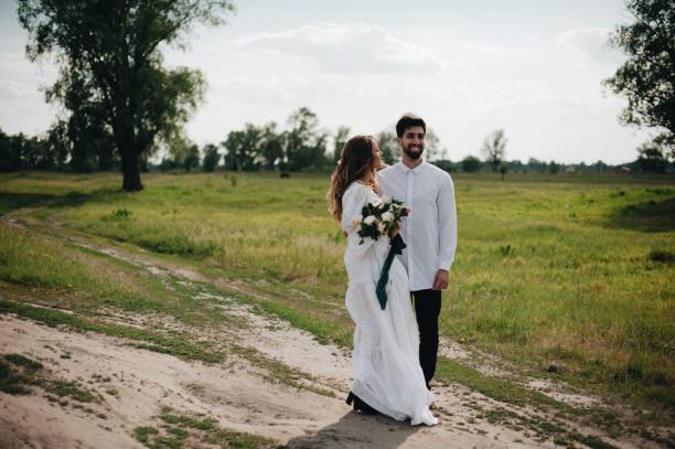 istock Bride And Bridegroom Standing On Field 1049848386