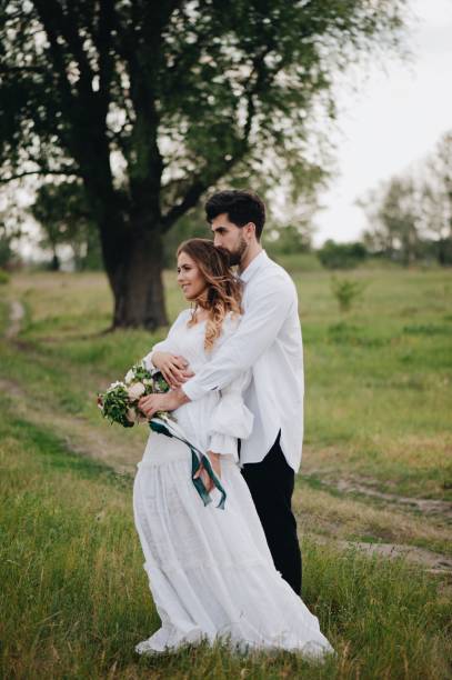 istock Bride And Bridegroom Standing On Field 1049848388
