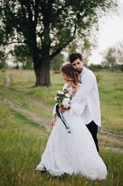 istock Bride And Bridegroom Standing On Field 1049848394