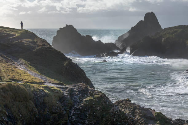 istock Walker in strong Winds, Kynance Cove, Cornwall 1049848856