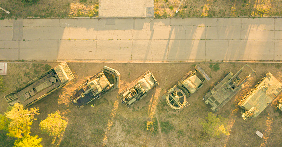 aerial view of row of military vehicles machines during sunset d