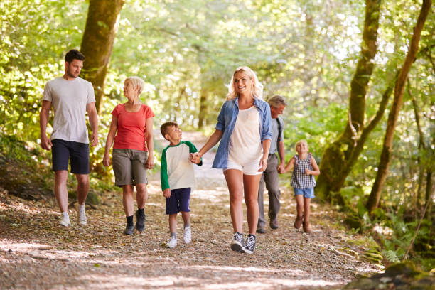 istock Multi Generation Family Enjoying Walk Along Woodland Path Together 1049854914