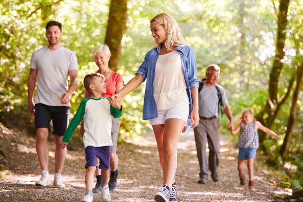 istock Multi Generation Family Enjoying Walk Along Woodland Path Together 1049856836