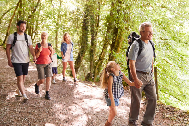 istock Multi Generation Family Enjoying Walk Along Woodland Path Together 1049857352