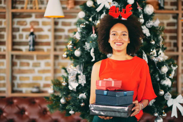 istock Mixed race woman holding gifts. 1049857408