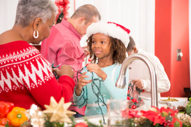 istock Multi-ethnic family in home kitchen decorating for Christmas. 1049858952