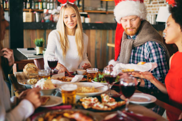 istock Friends having dinner on Christmas` eve at restaurant. 1049862582