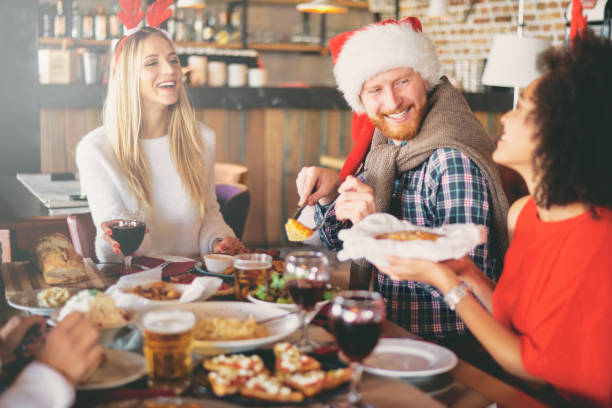 istock Friends having dinner on Christmas` eve at restaurant. 1049862824