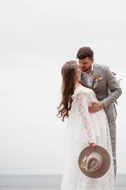 istock Bride And Bridegroom Standing Against Clear Sky 1049862930