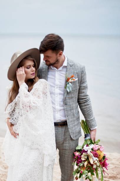 istock Bride And Bridegroom Standing At Beach During Wedding Ceremony 1049862950