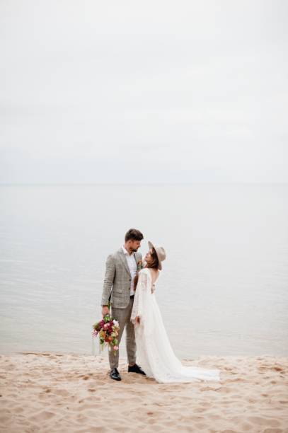 istock Bride And Bridegroom Standing At Beach During Wedding Ceremony 1049862984