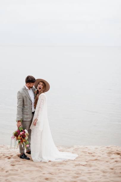 istock Bride And Bridegroom Standing At Beach During Wedding Ceremony 1049862988